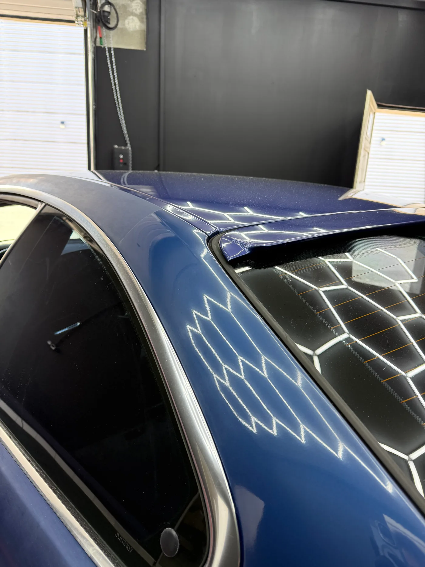 BMW E46 325i apres polissage chez Initial Detailing — reflet des LEDs hexagonales comme test miroir de la correction